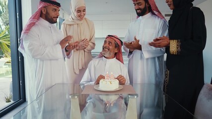 Arab family members celebrating a father's or grandfather's 60th birthday, gathering around him with warm smiles and a simple cake, showing strong love and family bonding
