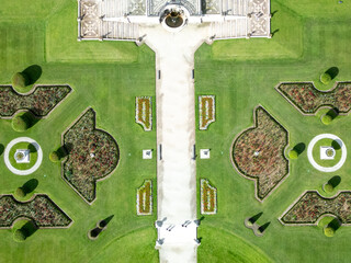 Aerial view of Powerscourt Estate Gardens, where symmetrical patterns of green lawns and flowerbeds meet pristine white pathways, Enniskerry, County Wicklow, Ireland.