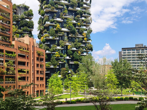 Milan, Italy &ndash; May 23, 2025: Modern residential towers of the Bosco Verticale complex rise above a landscaped urban park in the Porta Nuova district
