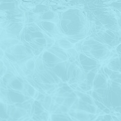 Soft blue water surface texture with natural light reflections creating abstract wave patterns.