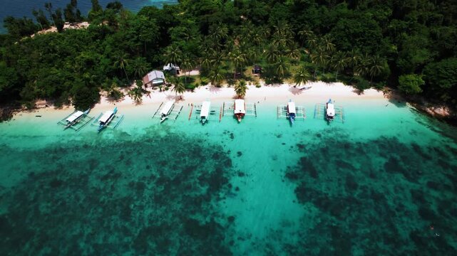 Beautiful tropical island with white sand and beaches surrounded by crystal clear blue water in Palawan, Philippines, South East Asia