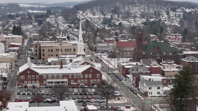 A slowly rotating parallax aerial establishing shot of the small town of Indiana, Pennsylvania in the winter. Grace Church in the distance. Non-snowing version available upon request. 14967  