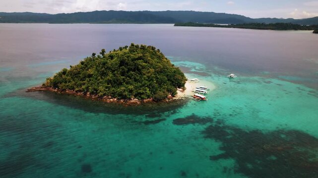 Beautiful tropical island with white sand and beaches surrounded by crystal clear blue water in Palawan, Philippines, South East Asia