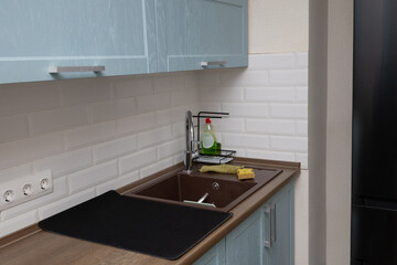 kitchen cabinets and a kitchen sink with a faucet on the countertop