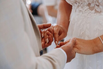 Close up of bride and groom holding hands during the solemn and intimate marriage ceremony, symbolizing commitment and love