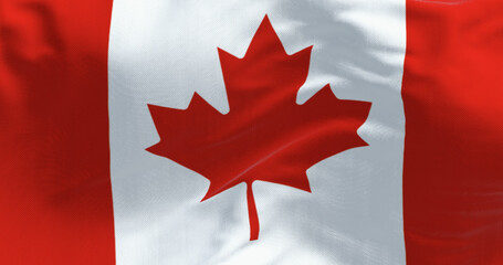 Naklejka premium Close-up of Canada national flag waving in the wind on a clear day