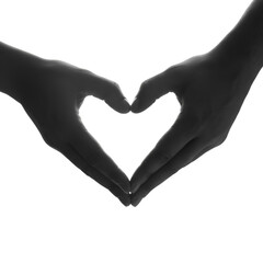 Obraz premium Close-up silhouette of two hands forming a heart shape, symbolizing love, care, and connection against a white backdrop.