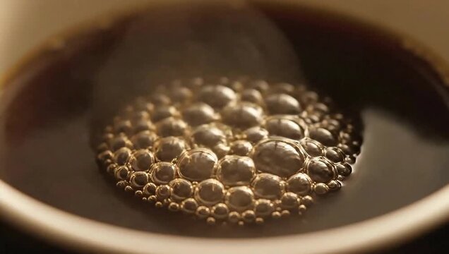 Bubbling Brew: A close-up view of a steaming cup of freshly brewed coffee, its surface adorned with a cluster of vibrant bubbles that dance playfully in the aromatic steam.
