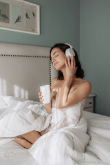Woman, headphones and happy on bed, relax and eyes closed with streaming subscription in home. Girl, person and smile with audio tech, sound and listening to music