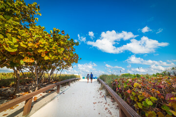 Young couple ona walk path to the beach