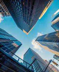 Skyscrapers in Midtown Manhattan under a blue sky