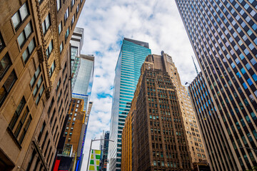 Skyscrapers in Midtown Manhattan under a cloudy sky