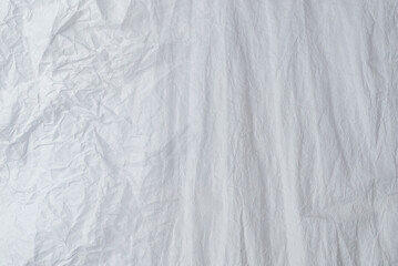Crumpled white paper background.