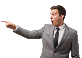 Astonished businessman in a grey suit and tie pointing to the left with an open mouth isolated on transparent background
