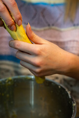 Female working and mixing dough for baking s-shaped yellow pastries, traditional Scandinavian holiday bakery