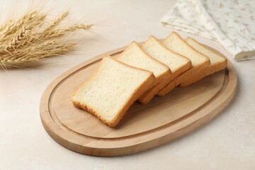 Slices of toast bread on beige table, closeup