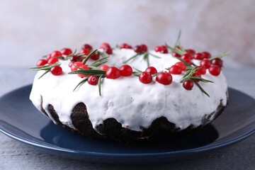 Tasty Christmas cake with cranberries and rosemary on gray wooden table, closeup
