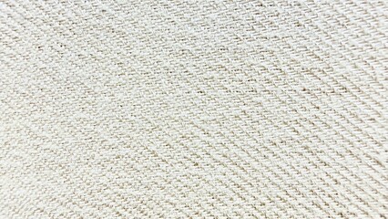 beige twill fabric texture close-up with diagonal weave pattern and light neutral tones