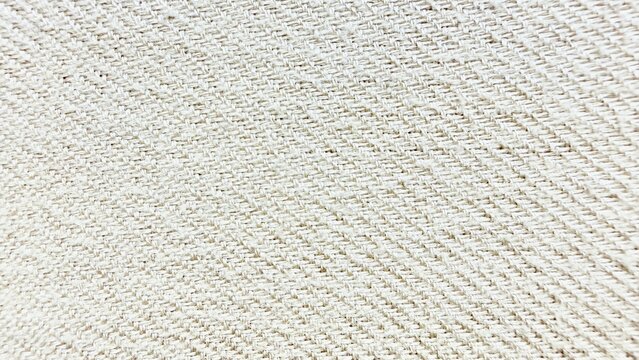 beige twill fabric texture close-up with diagonal weave pattern and light neutral tones