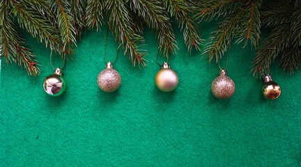 Green pine branches on a solid green background. Christmas green for the winter holidays.
Christmas tree decoration on a green background
