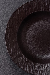 An empty round ceramic plate on a table, kitchenware. An empty plate