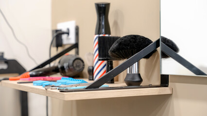 Barbershop tools and equipment on a wooden shelf