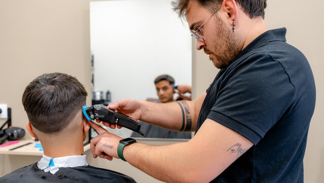 Barber giving a precise haircut with clippers