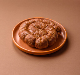 Grilled sausage in the shape of a spiral or snail, from chicken or pork. Spiral or snail sausage