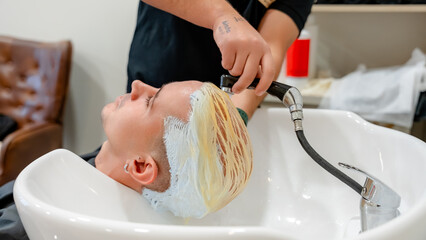 Hair bleaching session at modern barbershop