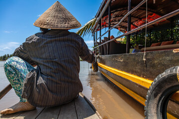 Local Woman Paddling Traditional Canoe by a Cruise Boat Mekong Delta, Vietnam