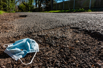 Discarded Face Mask at the Side of a Road