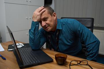 Stressed businessman leaning on hand