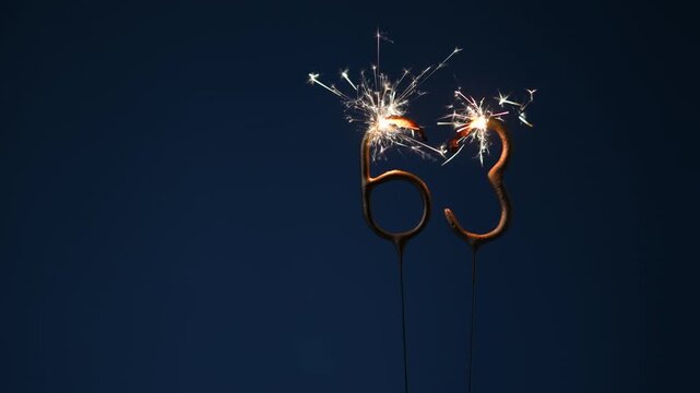 63 years celebration festive background made with Bengal fires in the form of number Sixty three.