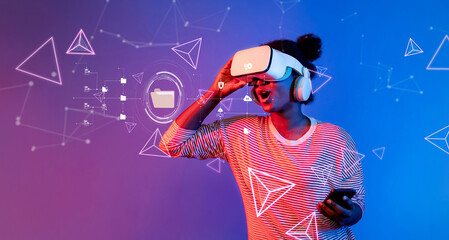 A young woman immerses herself in a virtual reality experience, blending technology and creativity against a vibrant blue and pink backdrop, showcasing modern digital interaction. XDMCP