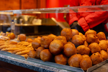 Pile of Fresh Dutch Traditional Fried Dough Oliebollen for Sale. Classic Winter Street Food in the...
