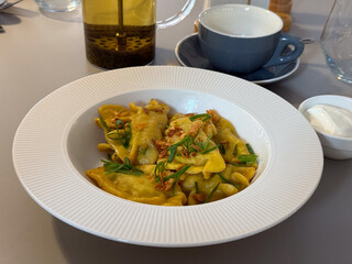 Ravioli lunch in cafe table setting. Comfort dining, restaurant cuisine, appetite, leisure, nutrition experience and relaxed meal atmosphere