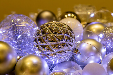 A close up of Christmas baubles and fairy lights, with a shallow depth of field