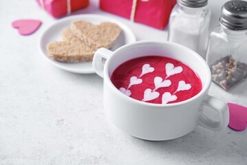 Beet soup puree with cream in the form of hearts for Valentine's day holidays