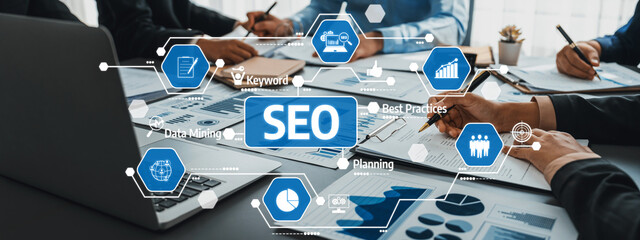 A dynamic business meeting focused on SEO strategies featuring data analysis, teamwork, and planning, showcasing various professional tools and charts. Amity