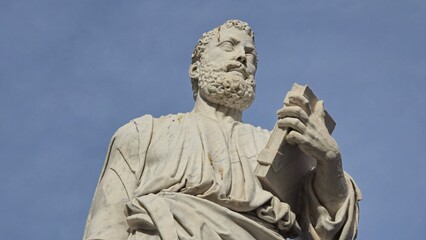 Obraz premium Rome, Italy - 12 January 2025. A close view of Saint Peter's statue near Castel Sant'Angelo shows him gripping a book, with fine carving in the beard and drapery.