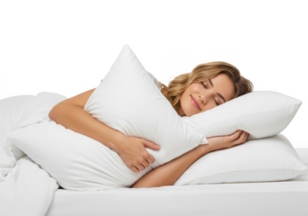 A young woman comfortably sleeps embracing a large white pillow in a soft bed against a dark background
