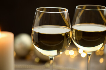 Glasses of white wine against blurred background, closeup. Christmas and New Year celebration