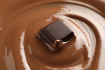 Tasty melted chocolate and piece as background, closeup