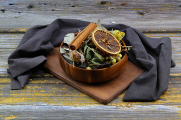 Winter tea for health in cold weather. Flavored with ginger, cinnamon, hibiscus, and orange. Isolated on woodenn background