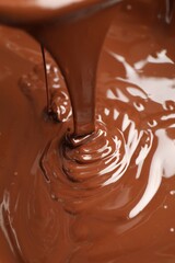 Tasty melted chocolate flowing down, above view
