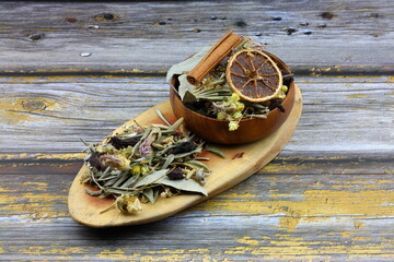 Winter tea for health in cold weather. Flavored with ginger, cinnamon, hibiscus, and orange. Isolated on woodenn background
