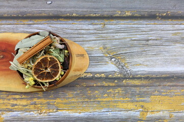 Winter tea for health in cold weather. Flavored with ginger, cinnamon, hibiscus, and orange. Isolated on woodenn background