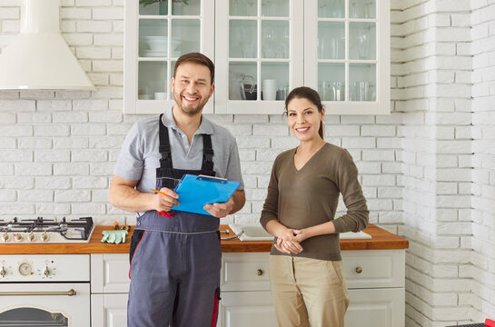 Portrait of positive, smiling handyman and client at home during kitchen maintenance, offering professional service and assistance in a friendly setting with focus on quality and care.