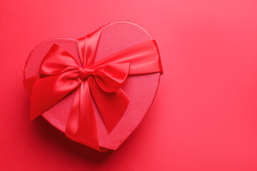 Happy Valentine's Day. Heart shaped gift box on red background, top view. Space for text