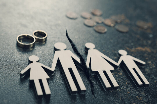 Divorce and alimony concept. Family figure with crack between wife and husband on table
